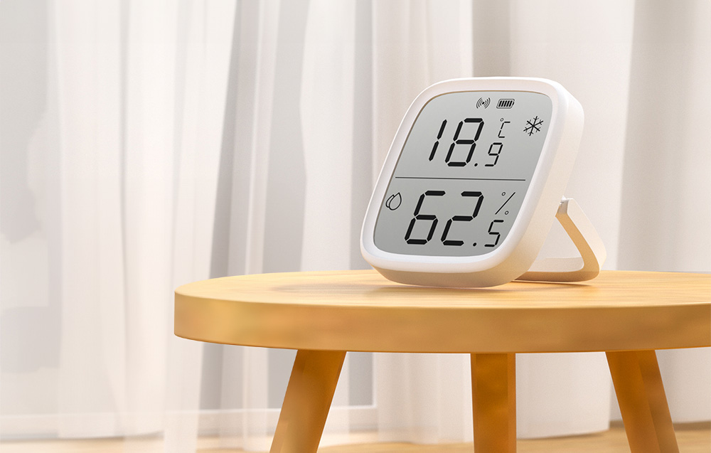 Czujnik temperatury i wilgotności na drewnianym stoliku w jasnym pomieszczeniu