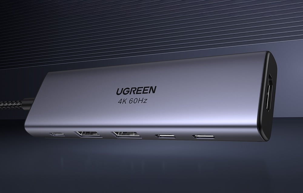 Aluminiowy hub UGREEN 4K 60Hz z kilkoma portami USB-C, USB-A i HDMI, widoczny z boku na ciemnym tle.