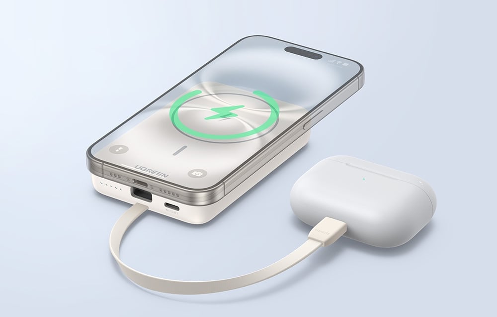 biały magnetyczny powerbank ładuje smartfona i słuchawki bezprzewodowe w etui