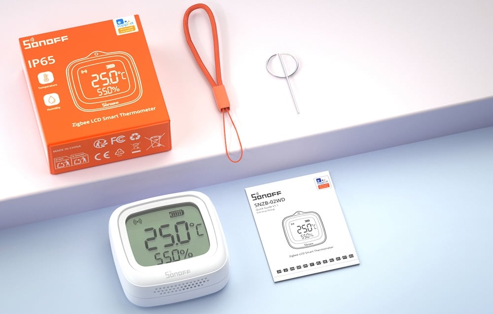 temperature and humidity sensor with orange packaging, instructions, and a tag