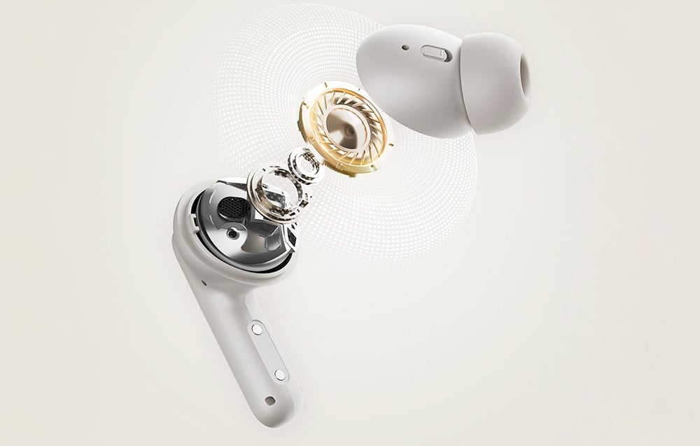  Biała słuchawka przedstawiona w przekroju z widocznymi elementami przetwornika i układu dźwiękowego.