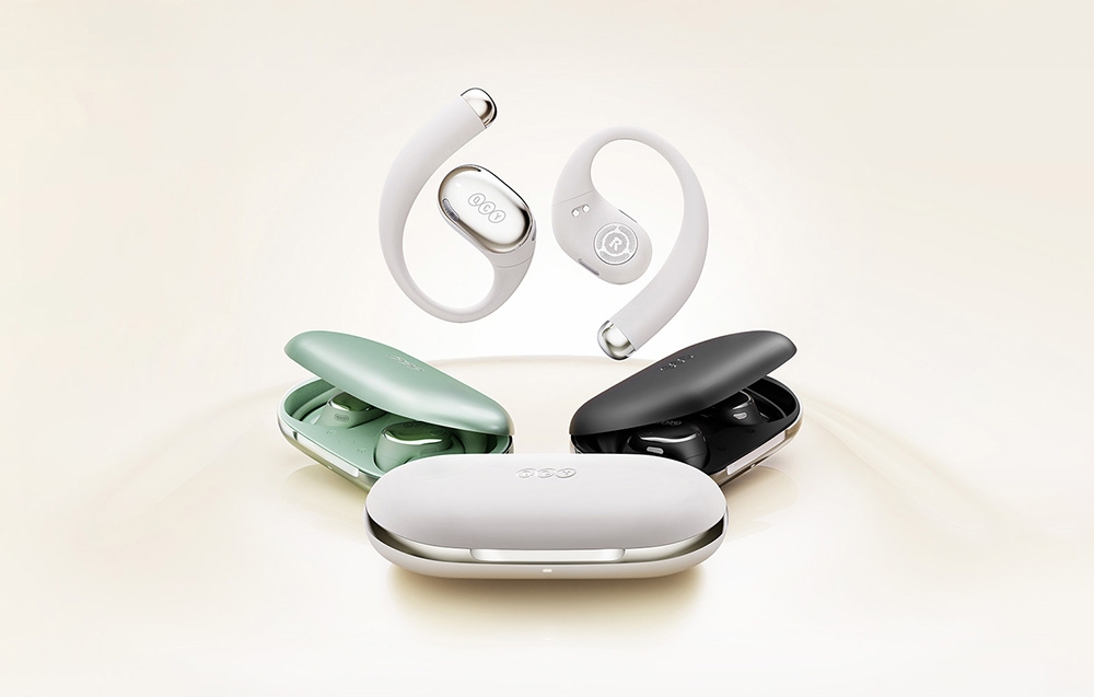 Kolekcja bezprzewodowych słuchawek w trzech kolorach - białym, zielonym i czarnym - z odpowiadającymi im etui ładującymi ułożonymi razem.