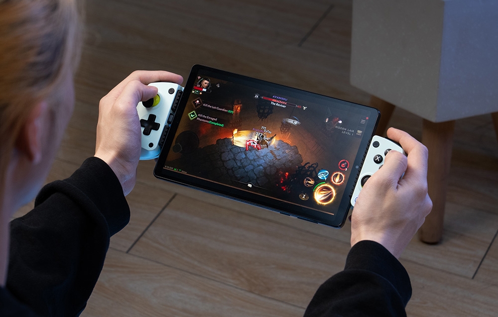 Osoba grająca na tablecie zamontowanym w kontrolerze GameSir z białymi uchwytami.