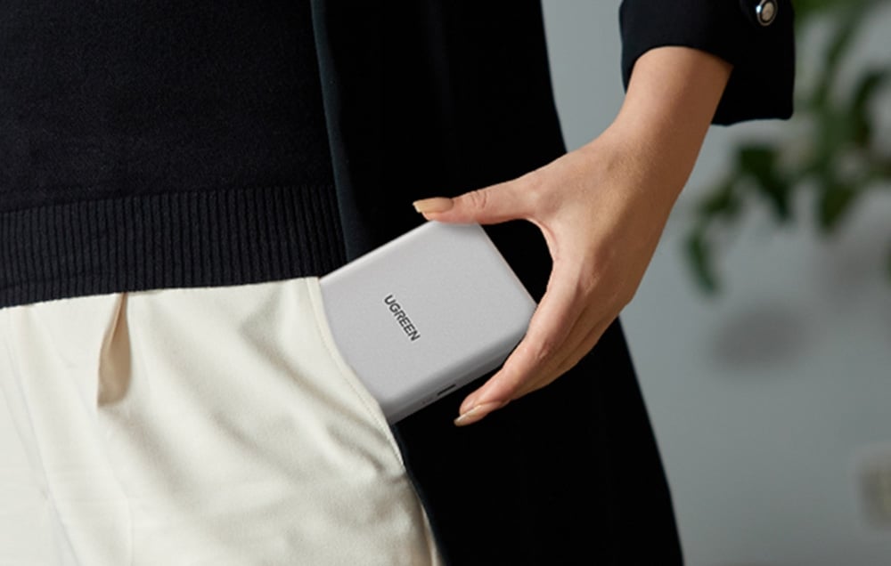 A person putting the drive enclosure into their pants pocket