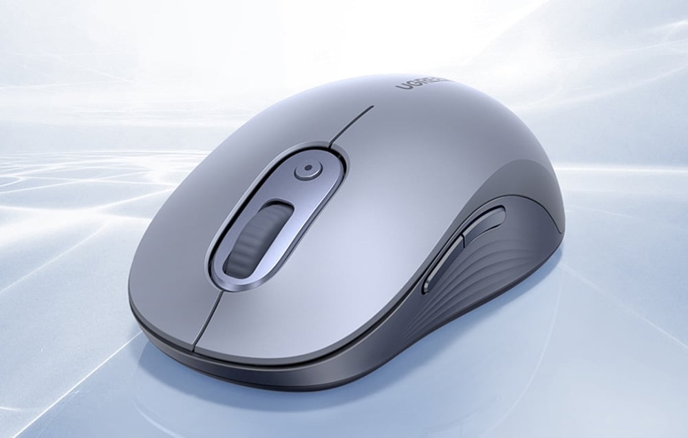 szara mysz komputerowa na jasnym tle ze wzorami