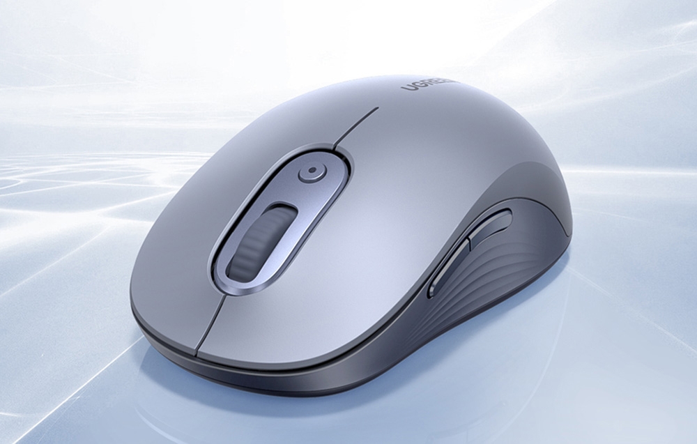 szara mysz komputerowa na jasnym tle ze wzorami