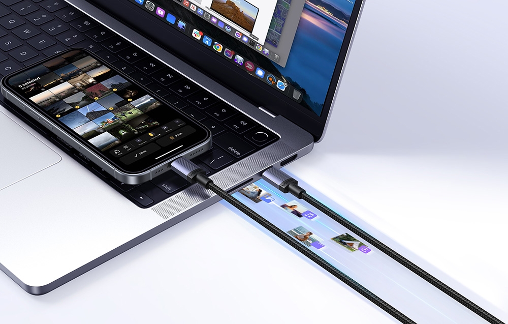 MacBook connected to an iPhone with a USB-C cable on a white background, showing photo transfer