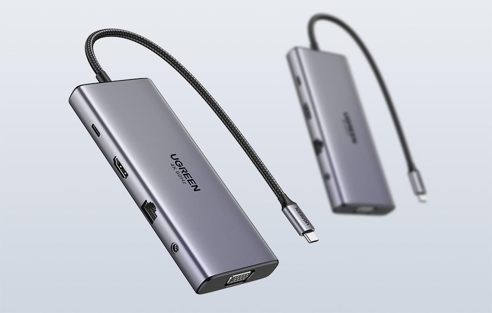 Dwa szare huby z wieloma portami i plecionym kablem na jasnym tle