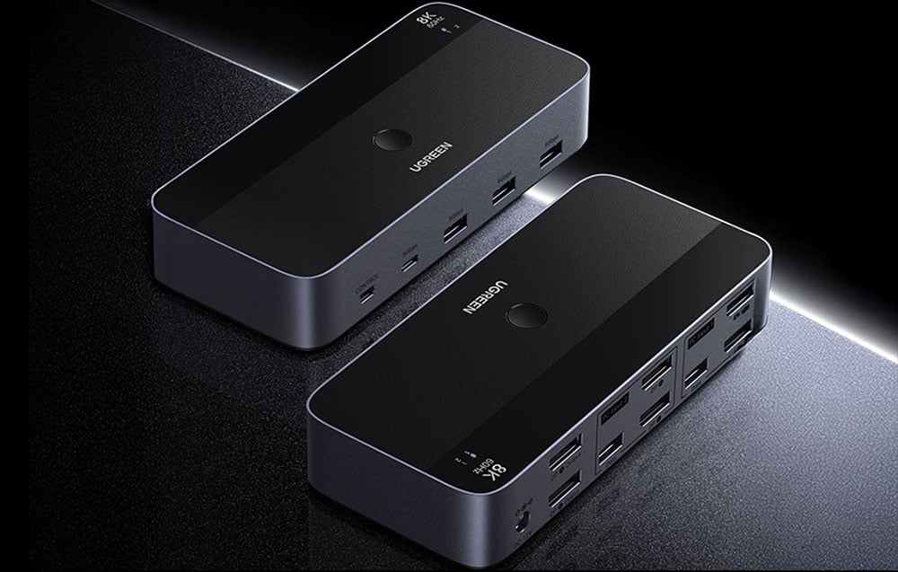 2 Ugreen switches lying on a black table.