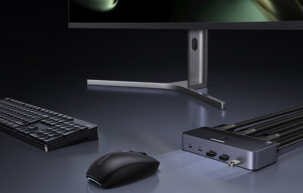 On the desk there are a keyboard, mouse, monitor, and switch.