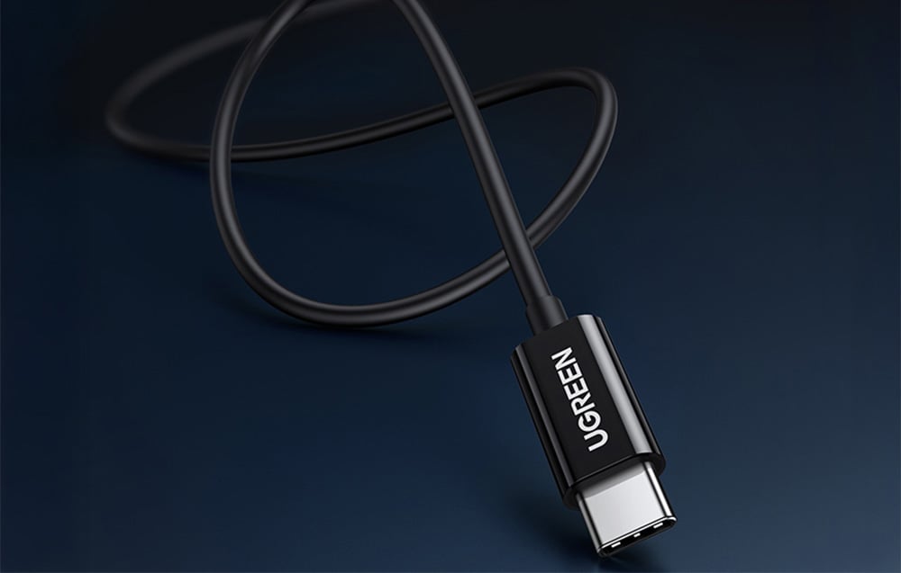 Close-up of a black USB-C cable from UGREEN on a navy background