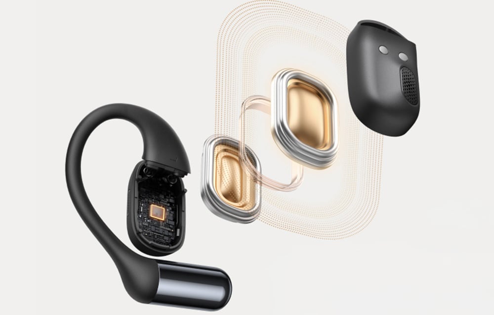 Rozłożony na części model czarnej słuchawki bezprzewodowej z widocznymi elementami wewnętrznymi