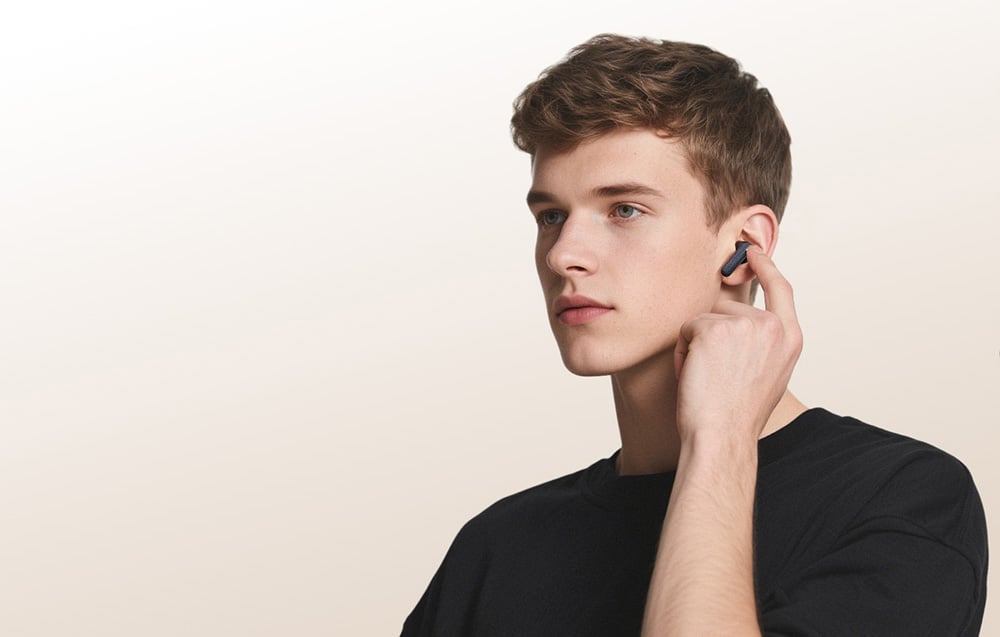 Young man with an earphone in his ear.