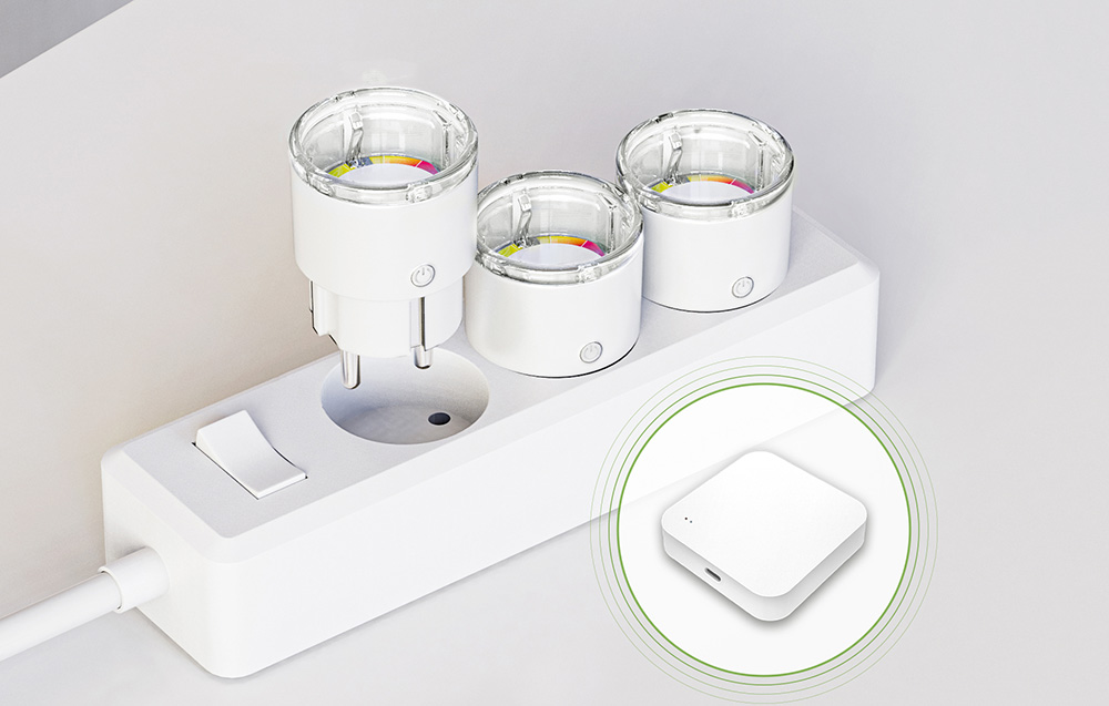 Three smart sockets plugged into a power strip, next to a visible white control module
