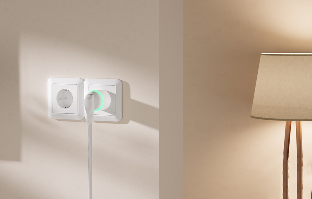 Smart socket with a connected cable and a glowing green ring, mounted next to a floor lamp