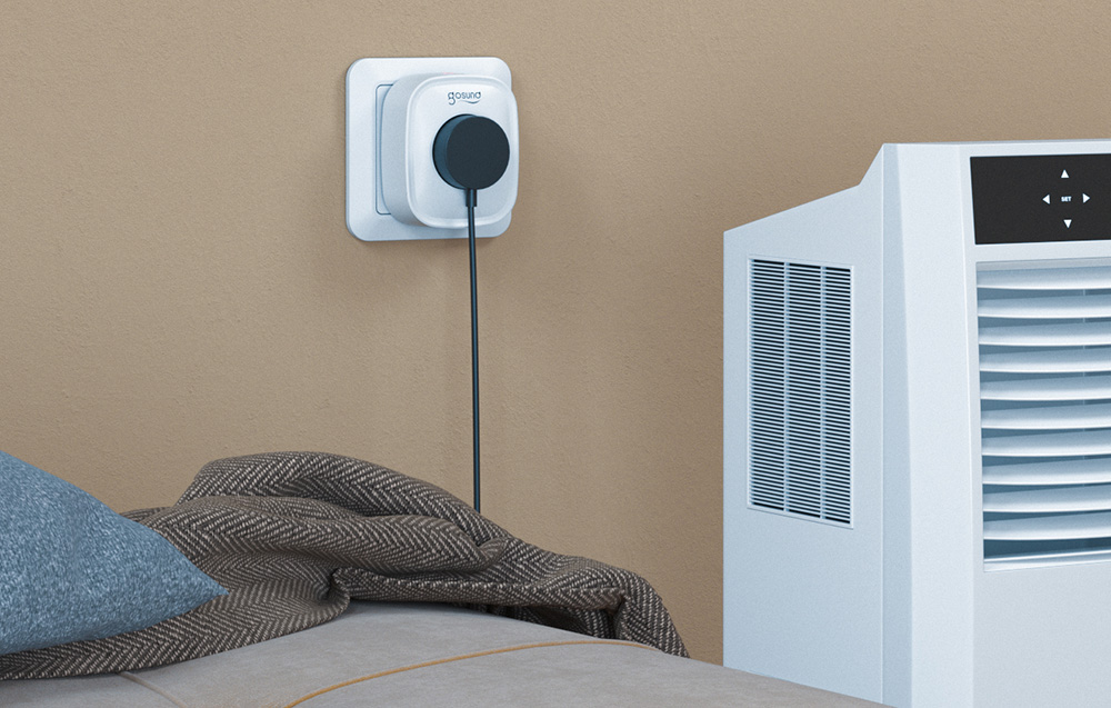 Smart socket by Gosund with a connected cable next to the bed, connected to a portable air conditioner