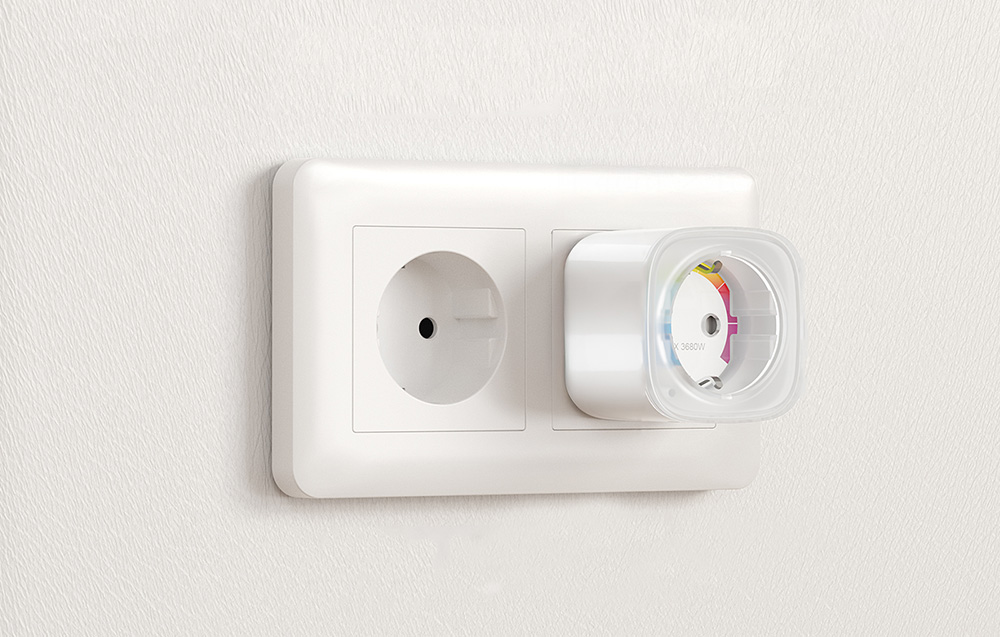 Smart socket plugged into one of two double wall sockets on a light wall