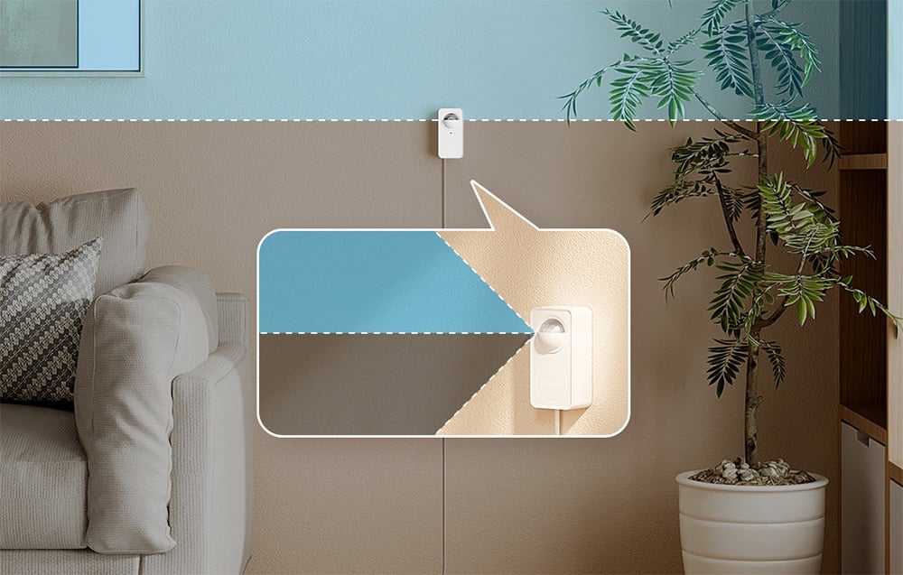 Czujnik ruchu zamontowany na granicy dwóch kolorów ściany, z powiększeniem pokazującym jego obecność na tle wnętrza