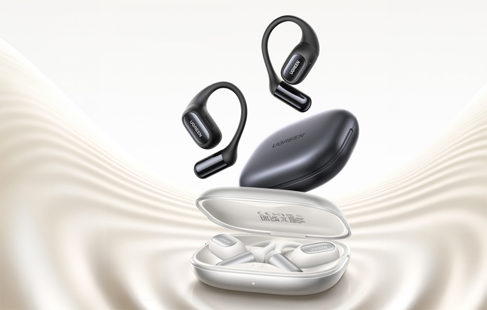 Białe i czarne słuchawki bezprzewodowe z etui na jasnym tle