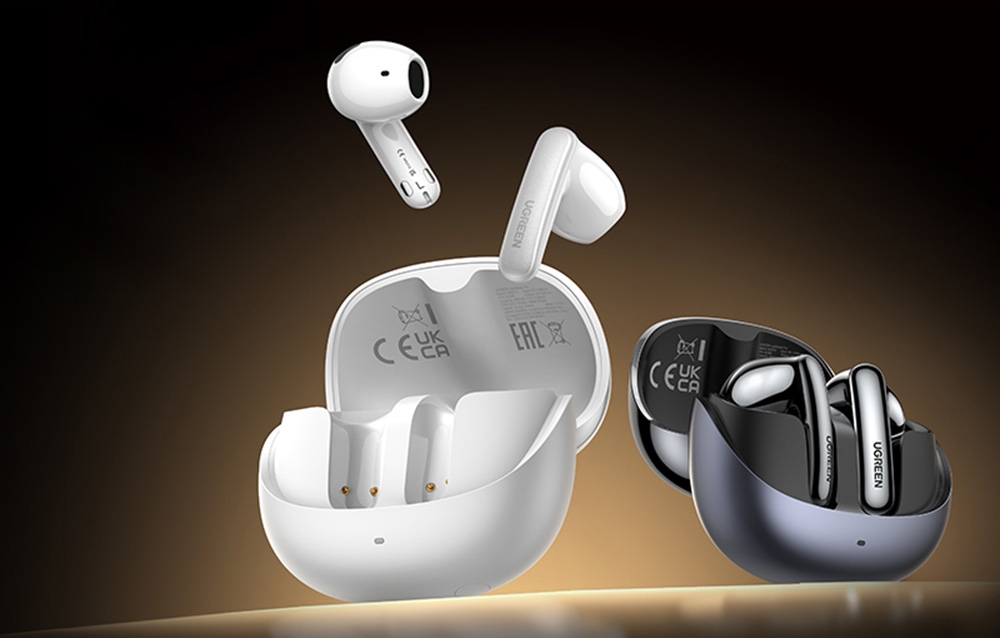 Białe i czarne słuchawki TWS z etui na ciemnym tle