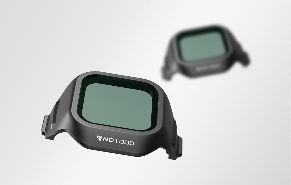 Two ND1000 filters with mint glass in black frames - one sharp in the foreground, the other blurred in the background
