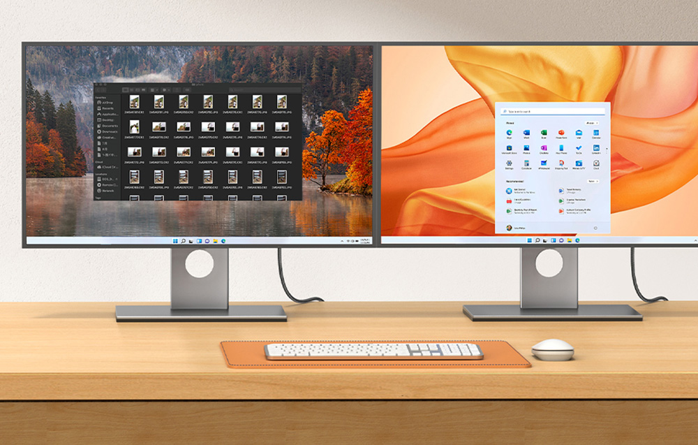 Zwei Monitore auf einem Schreibtisch mit Tastatur und Maus, die verschiedene Systemoberflächen anzeigen