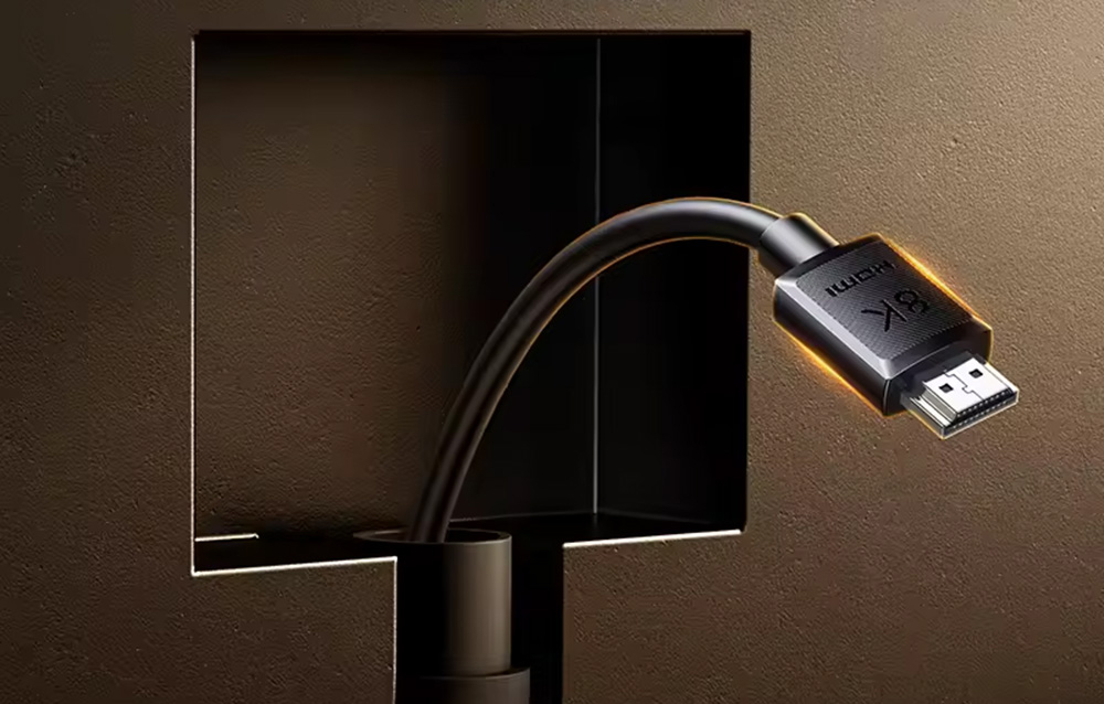 HDMI 8K Anschluss, der an das Rückpanel eines Monitors mit Beleuchtung auf dunklem Hintergrund angeschlossen ist