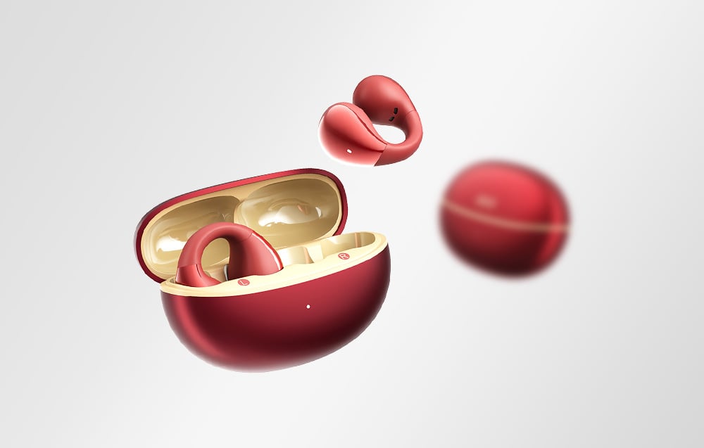 Czerwone słuchawki QCY w dwukolorowym etui ładującym z jedną słuchawką unoszącą się w powietrzu