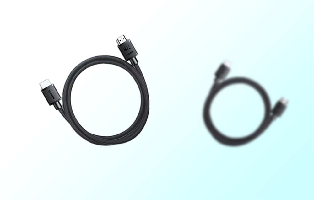 Cable with USB-C and HDMI ends in the foreground, with a blurred second instance in the background