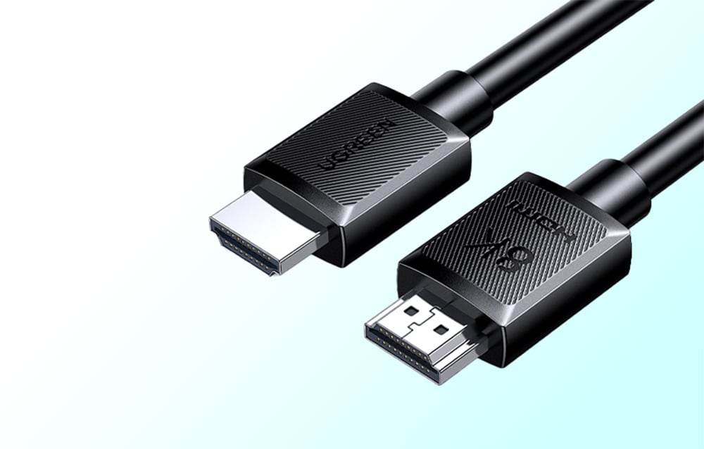 Close-up of two ends of a black HDMI cable, with visible UGREEN and 8K HDMI markings