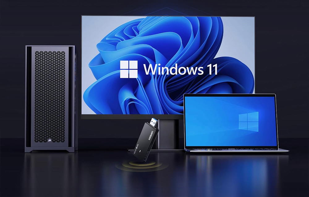 Windows devices on a black table and UGREEN USB network card