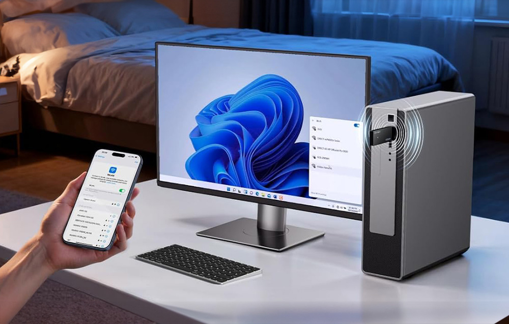 A smartphone held in hand, next to a computer with the network card connected