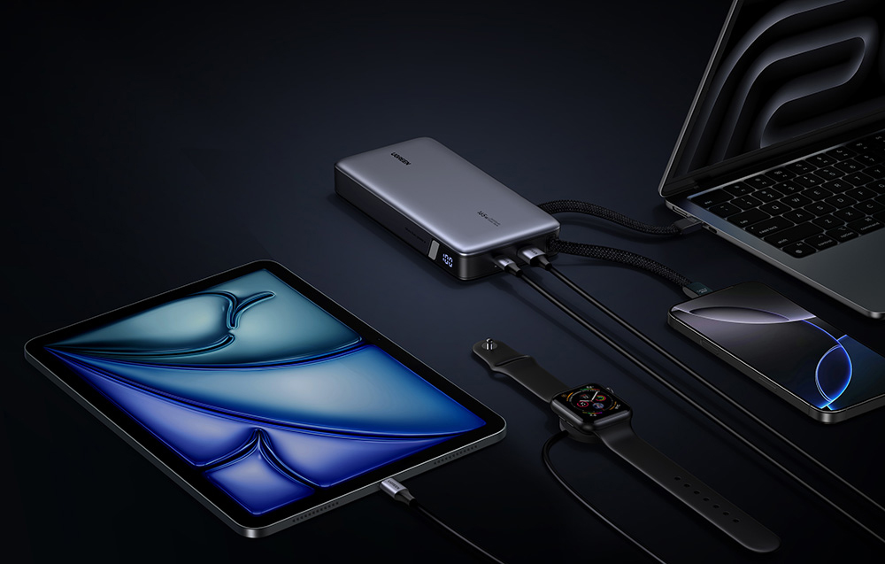 Various devices connected to the gray UGREEN powerbank on a dark background