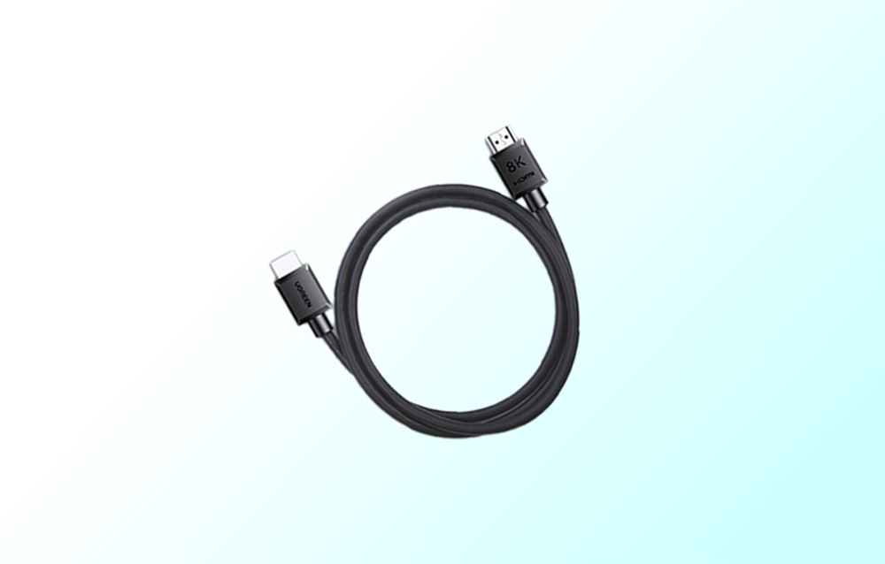 Black, coiled cable on a blue background