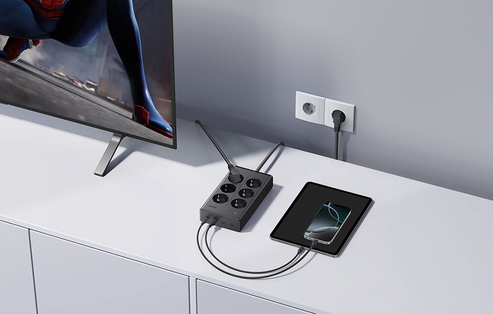 Power strip on a dresser, with a smartphone, tablet, and TV connected