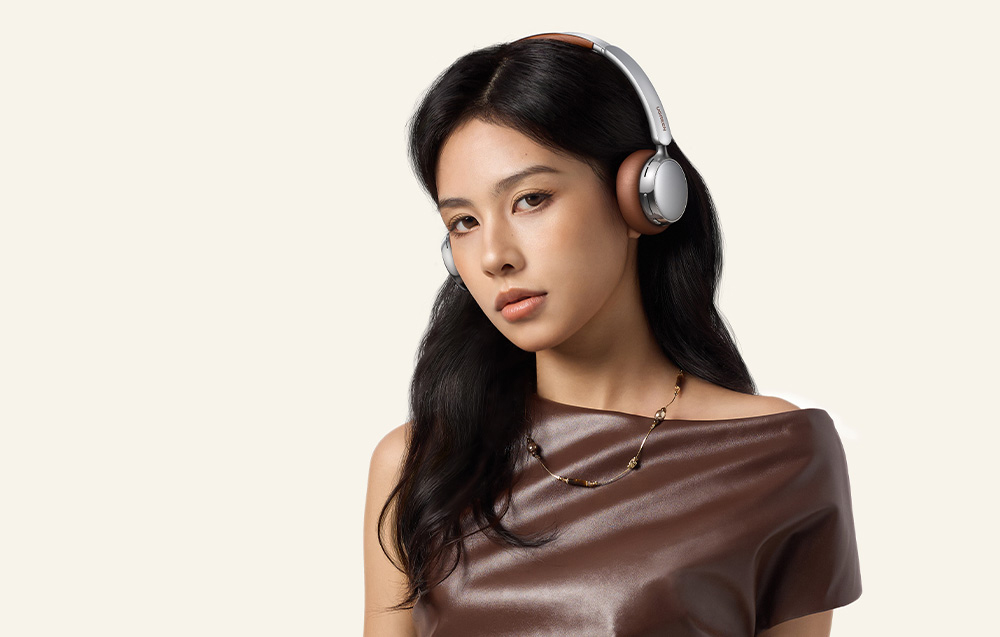 Woman in a brown dress wearing headphones