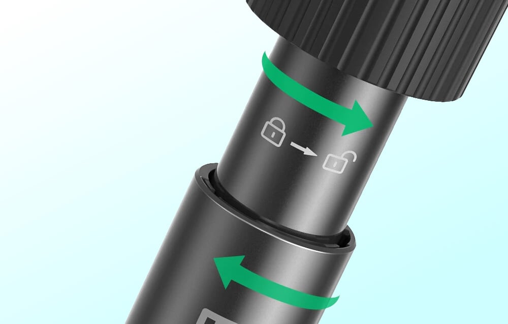 Zbliżenie na mechanizm blokady statywu z ikonami kłódki i strzałkami wskazującymi kierunek obrotu.