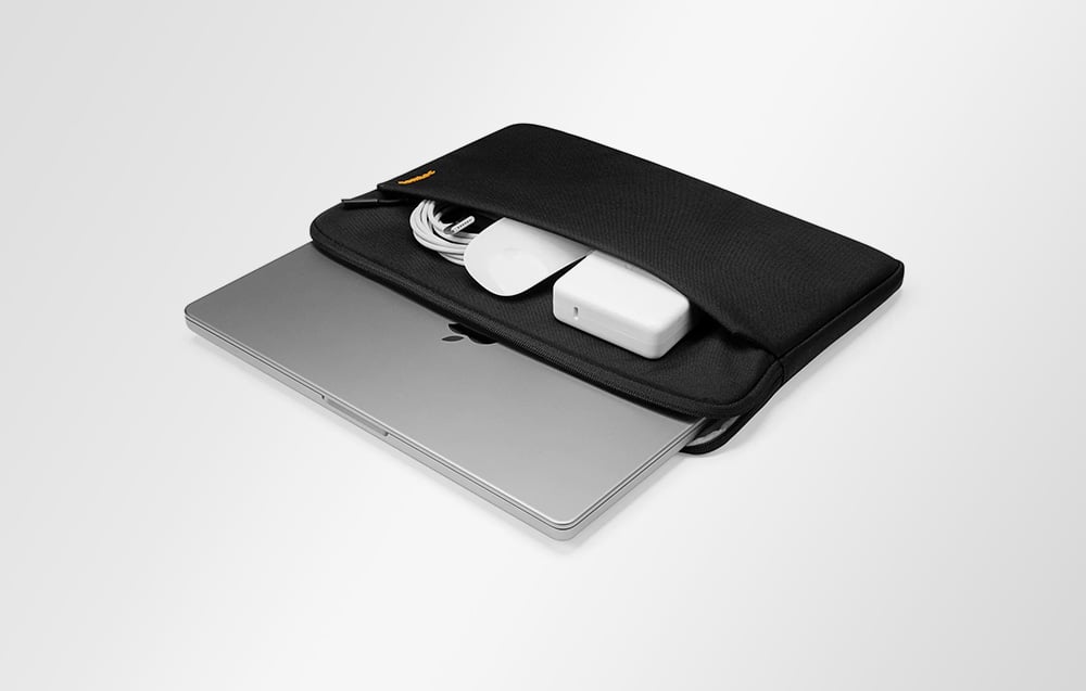 Black laptop sleeve with a laptop and accessories inside
