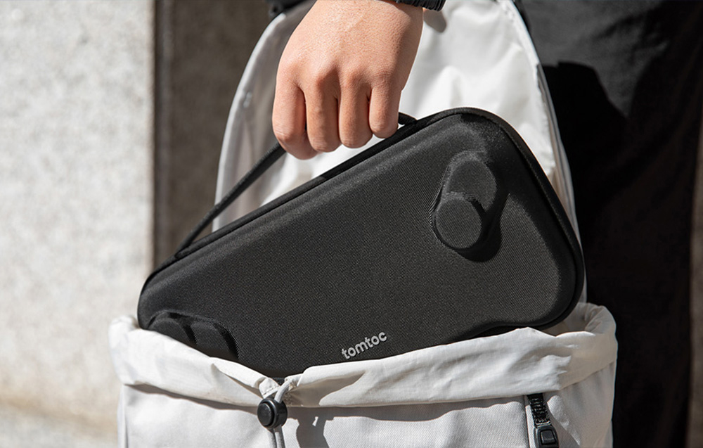 Black tomtoc console case being removed from a light bag