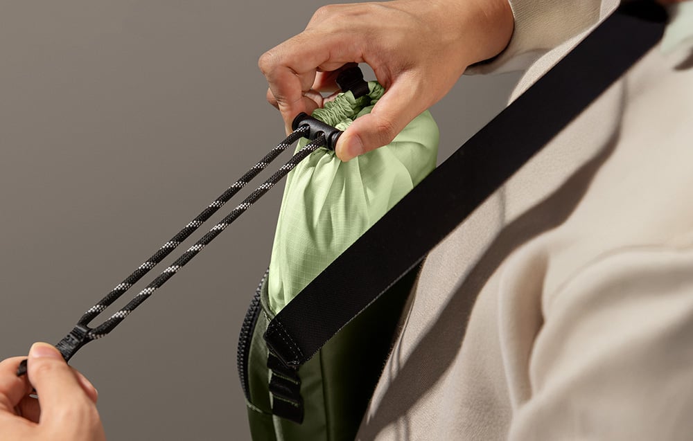 A green bag secured with a cord and special drawstring