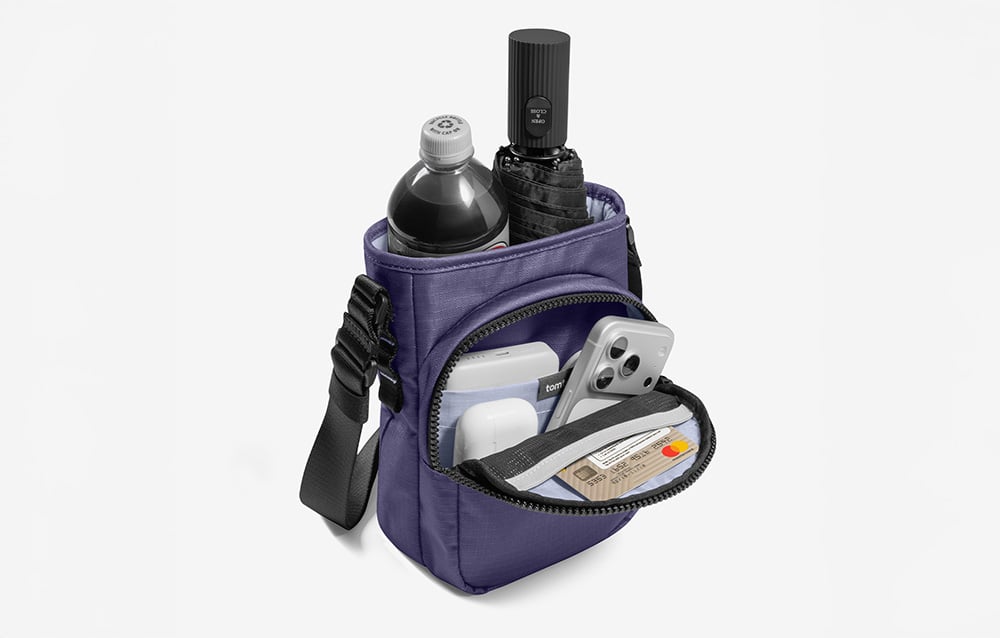Purple bag with a drink bottle, umbrella, and other accessories