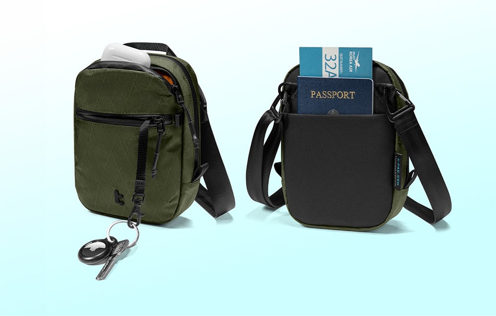 2 green bags with documents, headphones, and keys with an airtag