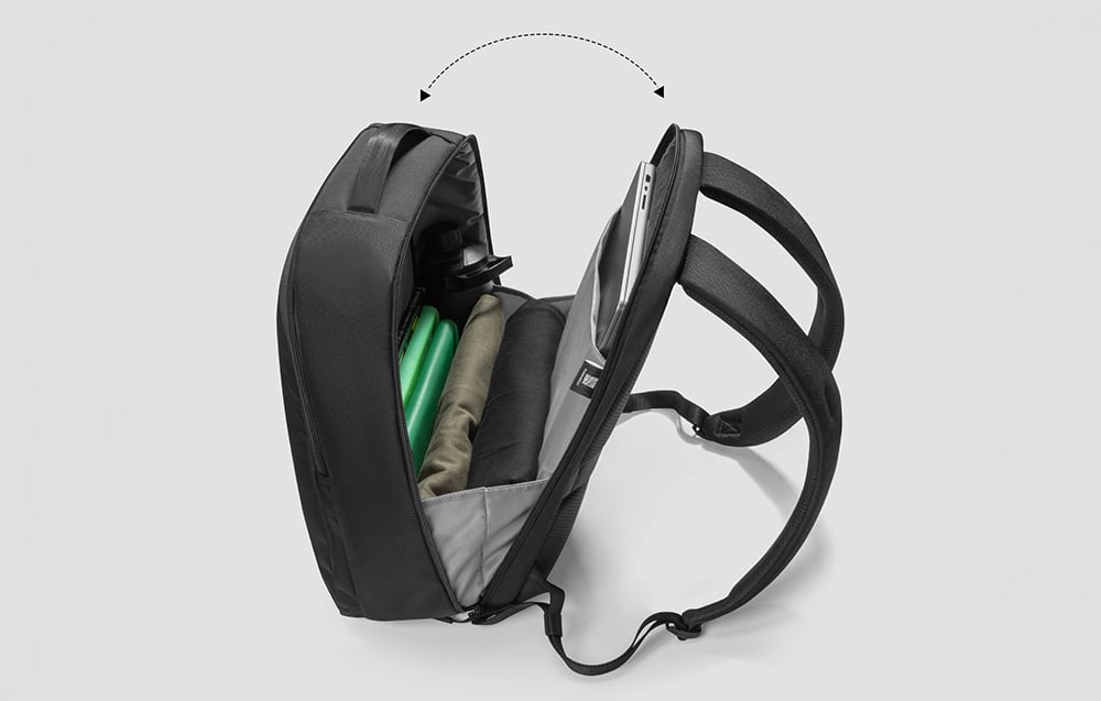 open laptop backpack showing its interior with accessories and a laptop