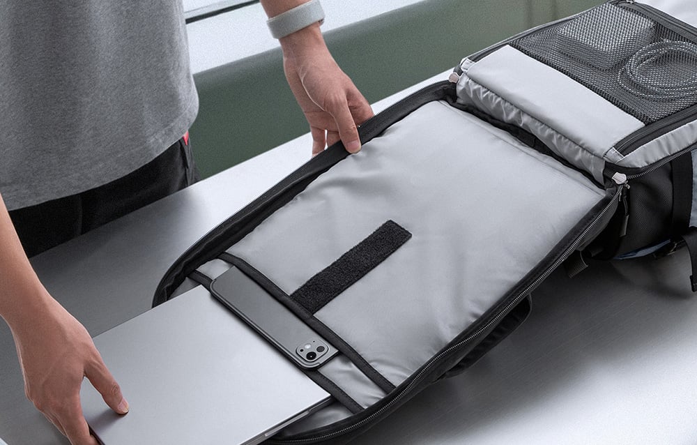 Open main compartment of the Tomtoc Navigator T66 backpack with a laptop and organizers