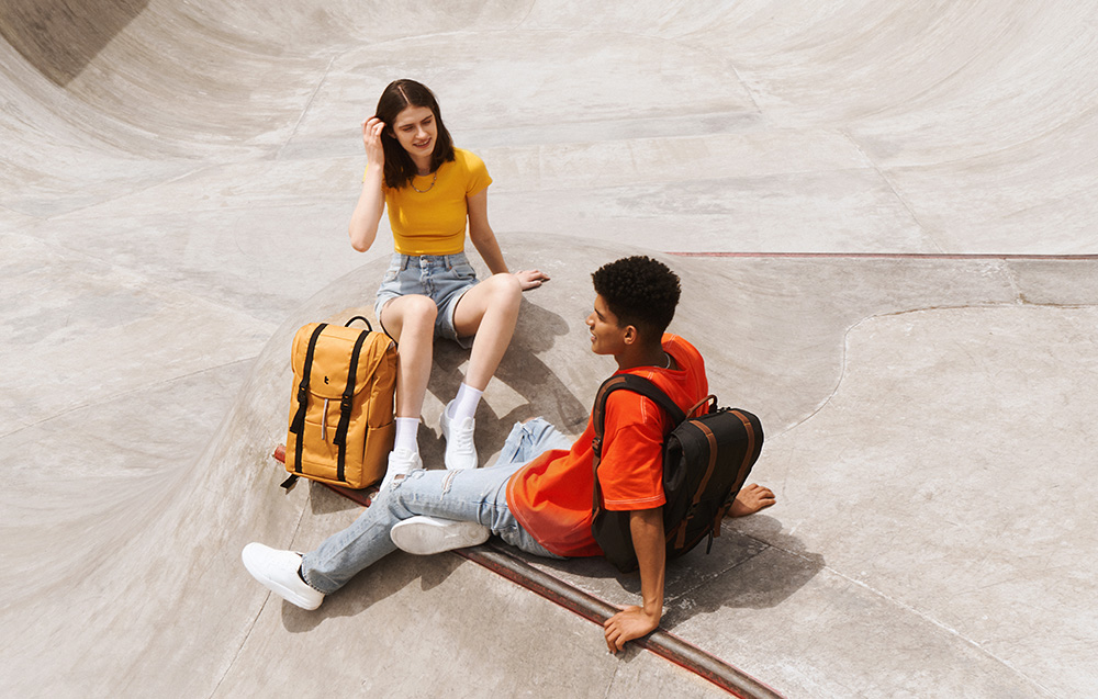 A boy and a girl sitting on a ramp