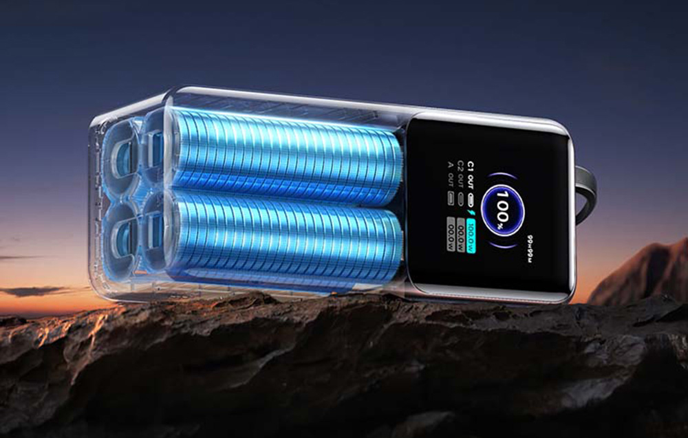 Wizualizacja wnętrza powerbanka z niebieskimi ogniwami akumulatorowymi, umieszczonego na skalistym podłożu o zmierzchu.