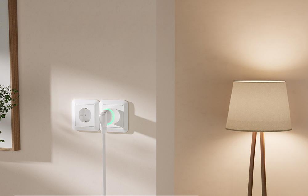 smart plug on a beige wall next to a lamp with a brown shade