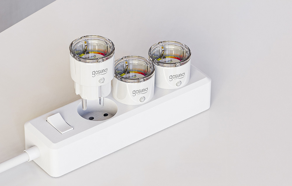 three smart plugs in a white power strip