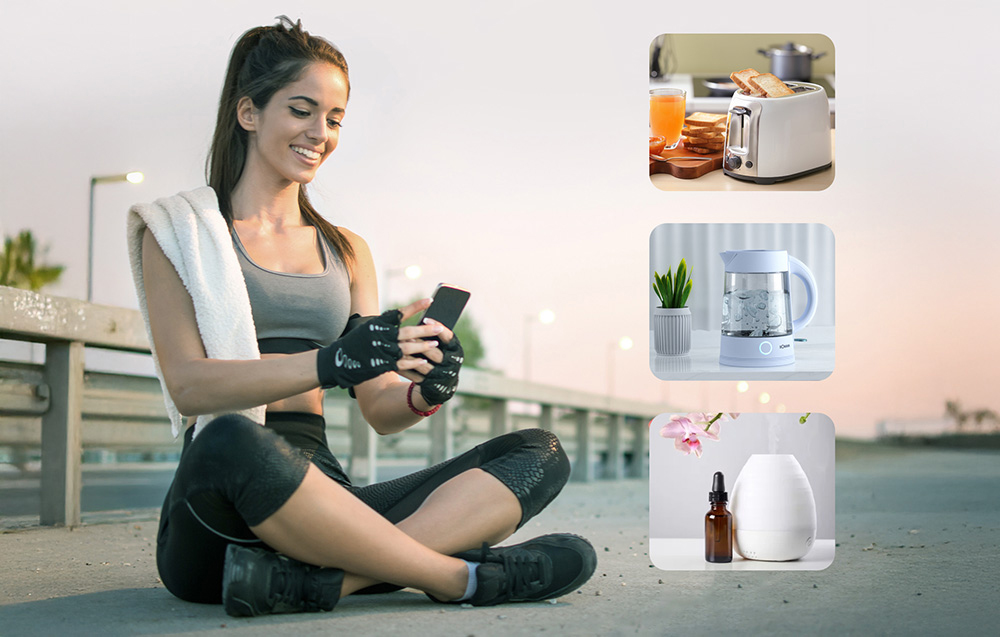 woman dressed in sportswear with a phone in hand controlling devices at home - toaster, kettle, and humidifier
