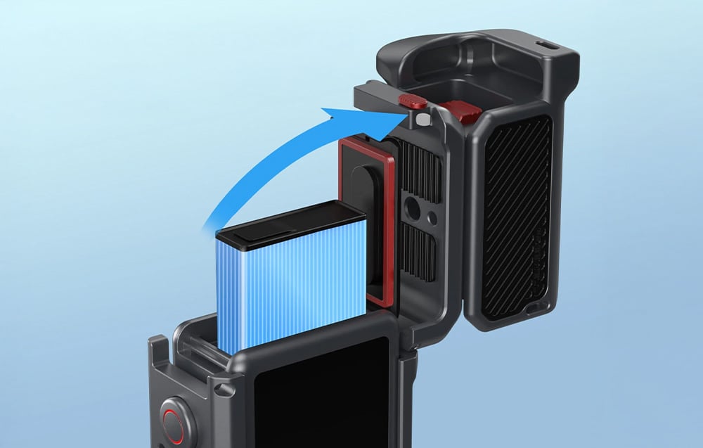 Inserting the battery into the sports camera located inside the open Freewell housing